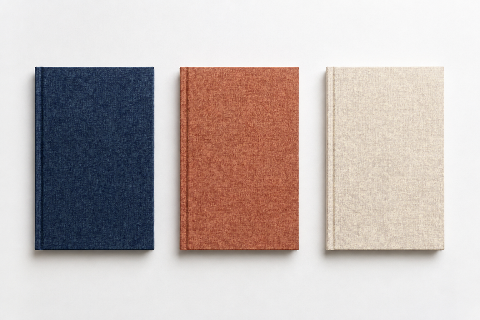 Illustrative navy, terracotta and cream linen notebooks